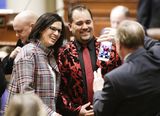 Representative Lucero and Representative Haley smile for a photo that is being taken by Representative Vogel in the House Chamber.