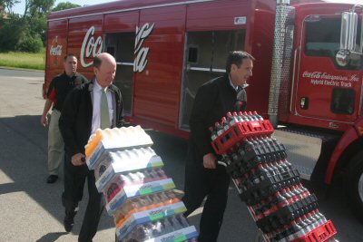 Governor Pawlenty and John Brock, Chairman and CEO of Coca-Cola Enterprises, ceremoniously deliver C...