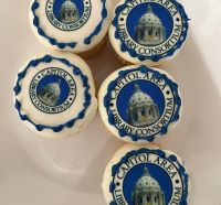 Five CALCO-themed cupcakes arranged on a platter.