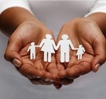 Hands holding a chain of a paper cutout family